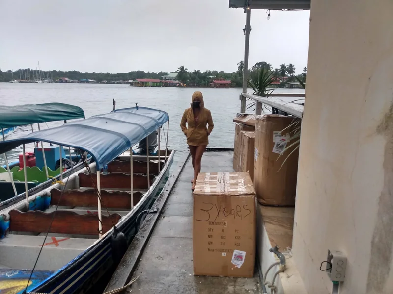 Heather beside boxes prepared for the boat transfer in Bocas del Toro